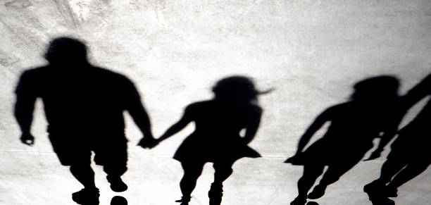 istock Blurry shadow silhouette of people walking on a summer day 1330444735