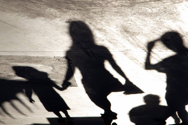 Blurry shadow silhouette of a family walking  on a summer day stock photo