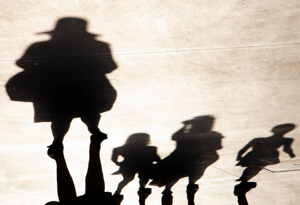 istock Blurry shadow silhouette of people walking on a summer day 1330444749