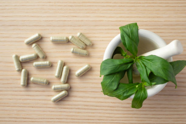 istock Herbal medicine capsules with Andrographis paniculata leaf on wood table 1330446442