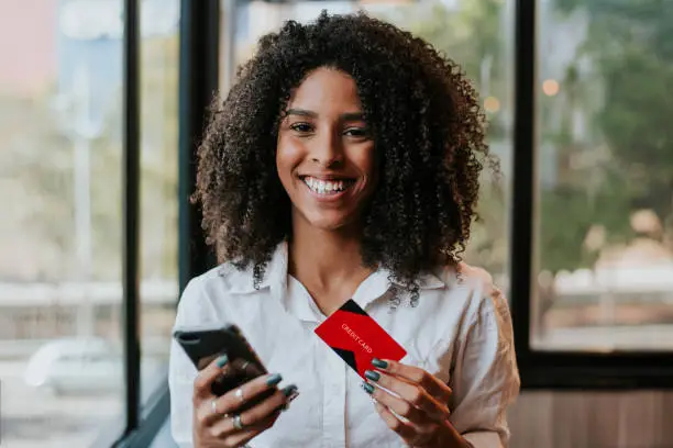 Photo of woman holding credit card