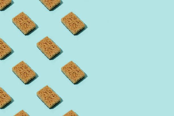 istock Pattern with neutral beige clean sponges for home cleaning on blue background. Banner for your site, concept for laundry, cleaning service, advertising, spring regular cleaning day, copy space 1330449241