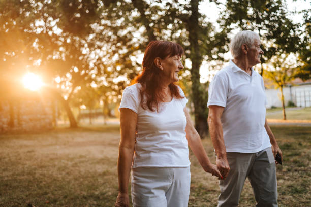 istock Cheerful senior couple taking a walk at sunset 1330449308