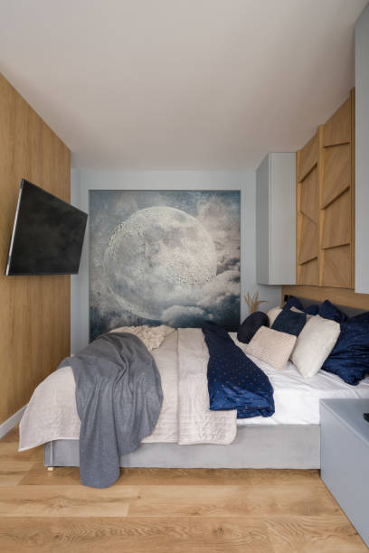 istock Small and stylish bedroom with moon wall mural 1330451336
