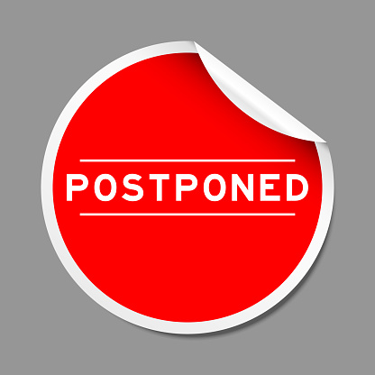 Red color peel sticker label with word postponed on gray background