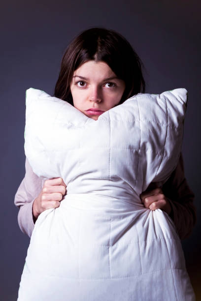 istock Funny girl with disgruntled offended face hugs a pillow. 1330473076