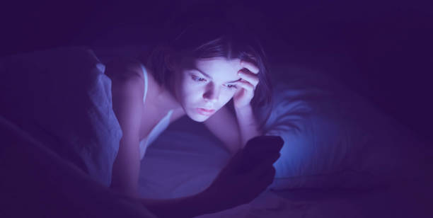 istock A woman with insomnia is watching a video online on a device. 1330473869