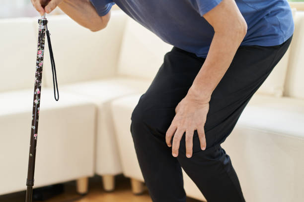 istock Elderly people with a sore knee and a cane 1330477266