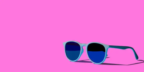 Photo of Colorful sunglass design with longside shadow on pink background with copy space.