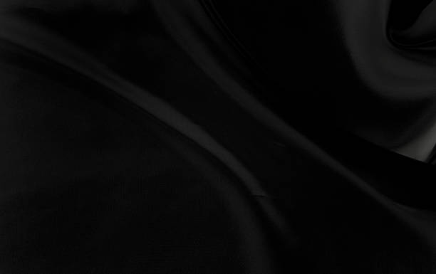 istock Black gray satin dark fabric texture luxurious shiny that is abstract silk cloth background with patterns soft waves blur beautiful. 1330480405
