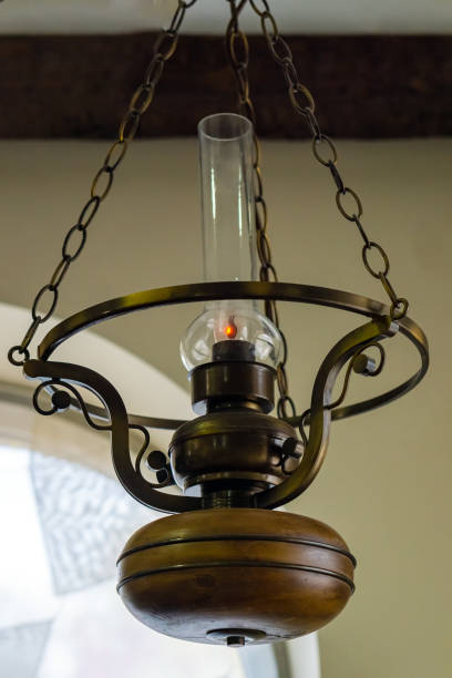 Lighting lamp made similar to an old kerosene lamp. Lighting lamp made similar to an old kerosene lamp. Inside is a light bulb. attic old light bulb loft apartment stock pictures, royalty-free photos & images