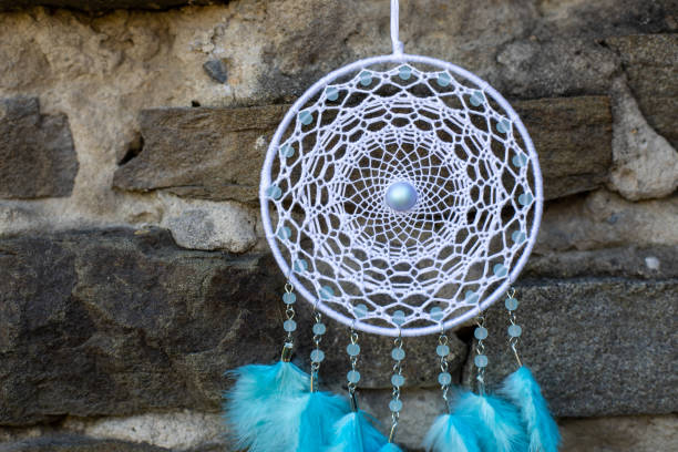 istock Handmade dream catcher with feathers threads and beads rope hanging 1330492658