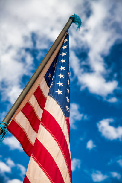 istock American flag against the blue sky. 1330495291