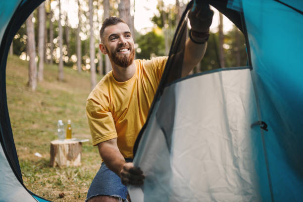 istock Happy man enjoying in camping 1330496622