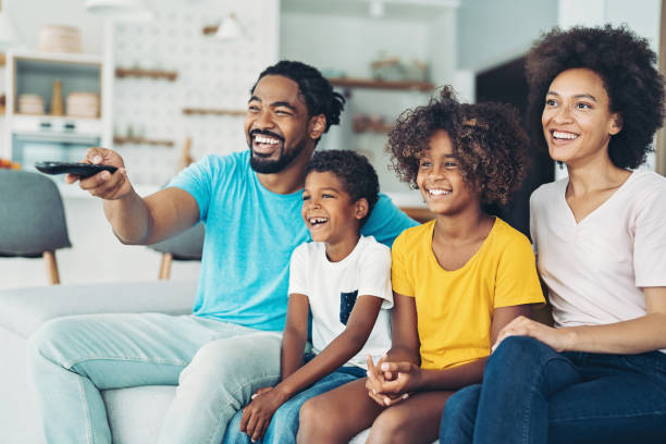 istock Parents and children watching TV together 1330497565