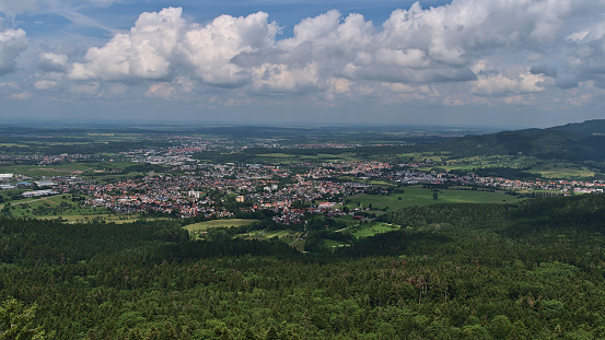 Aerial panoramic view over small town Balingen, Germany located on the foothills of low mountain range Swabian Alb surrounded by green forests and fields in summer viewed from Lochenhörnle.