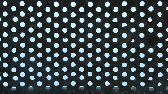 metal plank with a pattern of circular holes