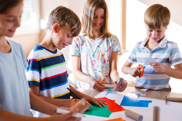 istock Children cutting paper for craftwork 1330502967