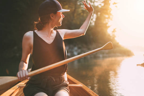 istock Woman wave hand from canoe 1330503123