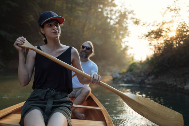 istock Couple paddling canoe on a forest lake 1330503140