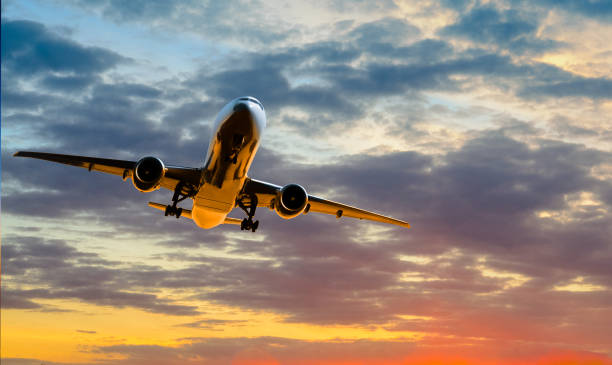 istock Plane goes on takeoff at sunset on cloudy sky background 1330507940