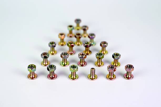 istock Bolts and nuts isolated in triangle formation. 1330508161