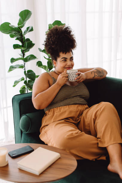 istock Relaxed woman drinking coffee at home 1330510286