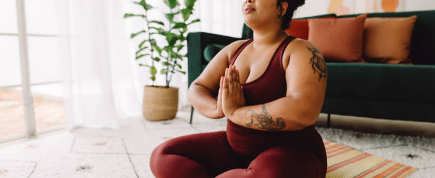 istock Plus size female practicing yoga meditation at home 1330510288
