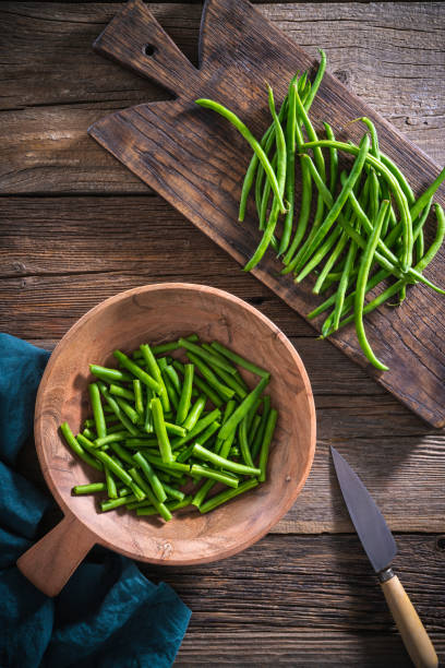 istock Green beans cut with knife on rustic wood table 1330510461