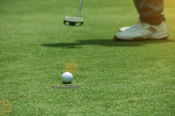 istock Golfers are putting golf in the evening golf course 1330510829