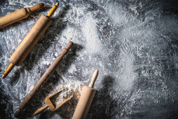 istock Rolling pin and flour serving scoop on flour spread background abstract for bakery themes 1330510947