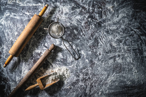 istock Rolling pin and flour serving scoop on flour spread background abstract for bakery themes 1330510969