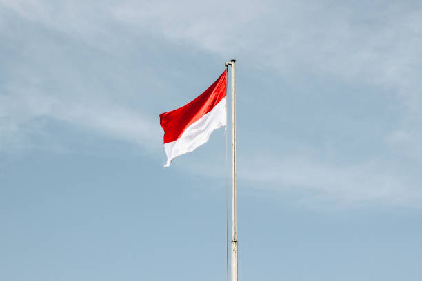 istock Flag of Indonesia with Blue Sky Background 1330511196