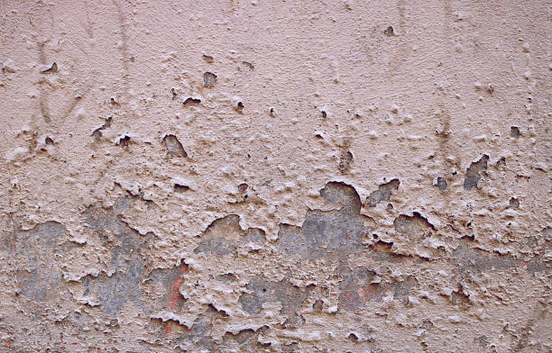 istock old gray wall of concrete with peeling paint - rough dirty texture for a background surface 1330513511