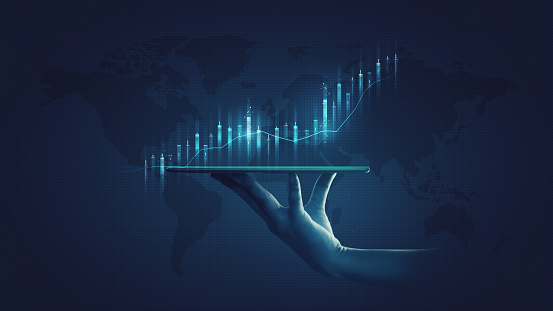 Businessman holding stock tablet and market economy graph statistic showing growth of profit analyzing financial exchange on increase digital money background with trade chart finance data concept.