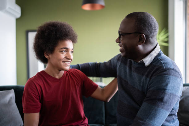 istock Father and son talking and embracing at home 1330516465