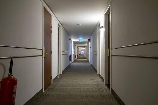 A hotel corridor in a futuristic hotel. Room doors and stairs. High quality photo