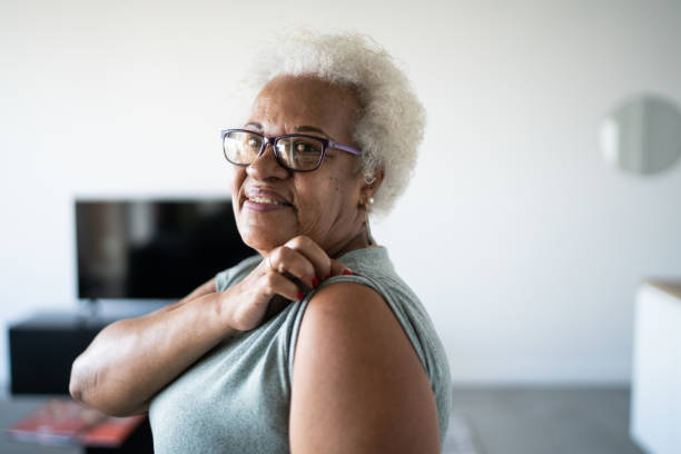 Portrait of a senior woman showing arm to take vaccine Portrait of a senior woman showing arm to take vaccine rolled up sleeves stock pictures, royalty-free photos & images