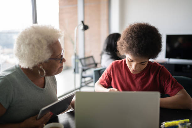 istock Grandmother helping grandson with homework 1330519009