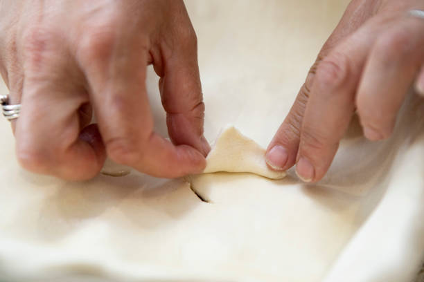istock Decorating the top of a puff pastry pie 1330519824