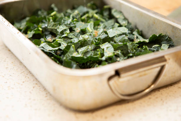 istock Chopped kale sprinkled with sugar in a stainless steel roasting tin 1330520348