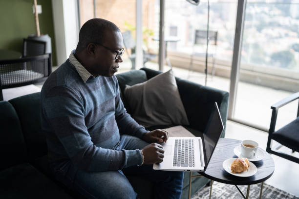 istock Mature man using laptop working at home 1330522676