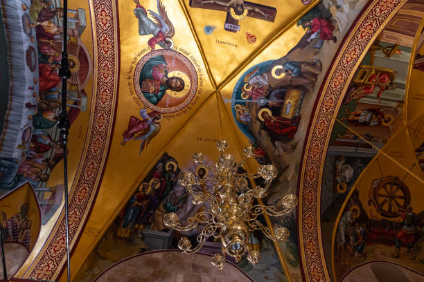 istock A large  decorative lamp hangs from a ceiling painted on religious themes in a hall in the small monastery of St. George on the border of the Jewish and Armenian quarters in the old city of Jerusalem, Israel 1330522735
