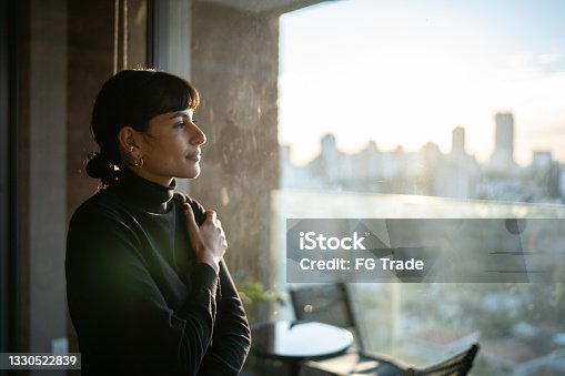 istock Young woman contemplating at home 1330522839