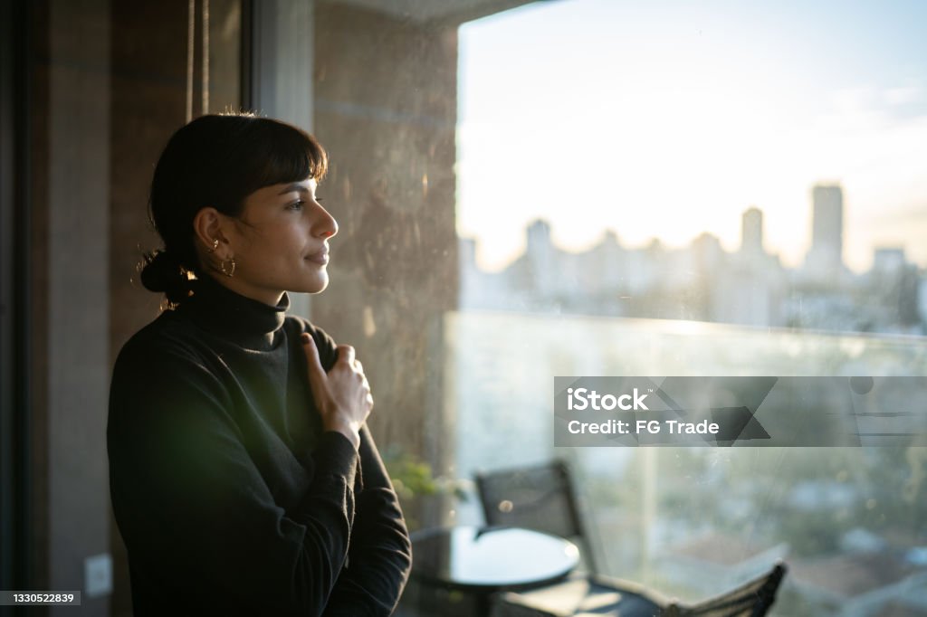 Young woman contemplating at home Mental Health Stock Photo