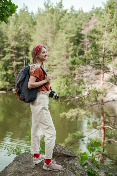 istock A hiker with a backpack and a camera around her neck is happy to see incredibly beautiful landscapes, this is her first local trip after quarantine 1330528874