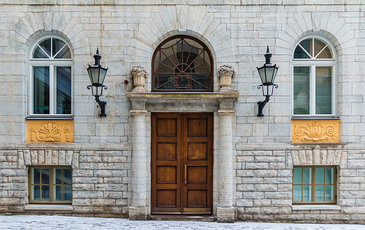 Several windows and door on the facade of the urban historic building front view, Tallinn, Estonia