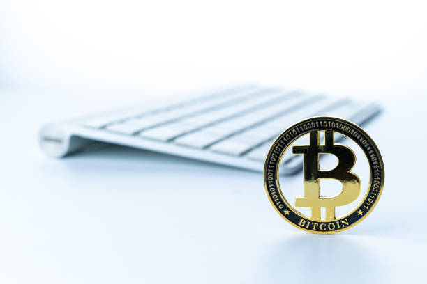 istock Bitcoin icon. Gold Crypto currency BTC Bitcoin with keyboard on white background. Golden Bit Coin virtual cryptocurrency or blockchain technology. Trading on the cryptocurrency exchange. 1330530476