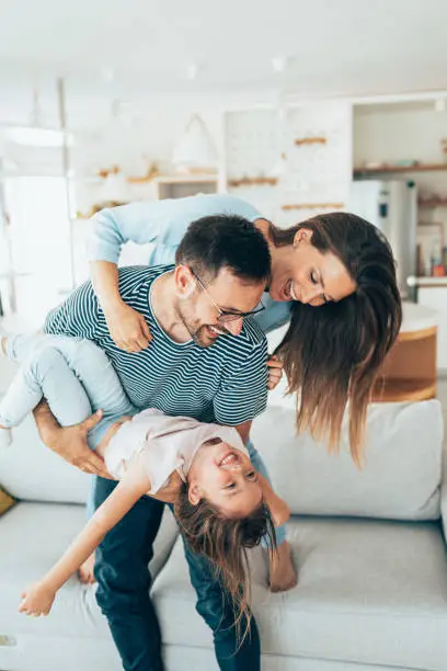 Family with daughter having fun at home