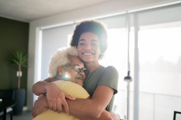 Portrait of grandmother and grandson embracing at home Happy grandmother and grandson embracing at home grandma portrait stock pictures, royalty-free photos & images